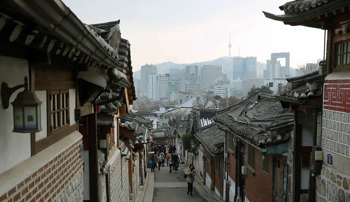 Tiled hanok rooftops stepping down a hillside in Bukchon Hanok Village, Jongno-gu, Seoul