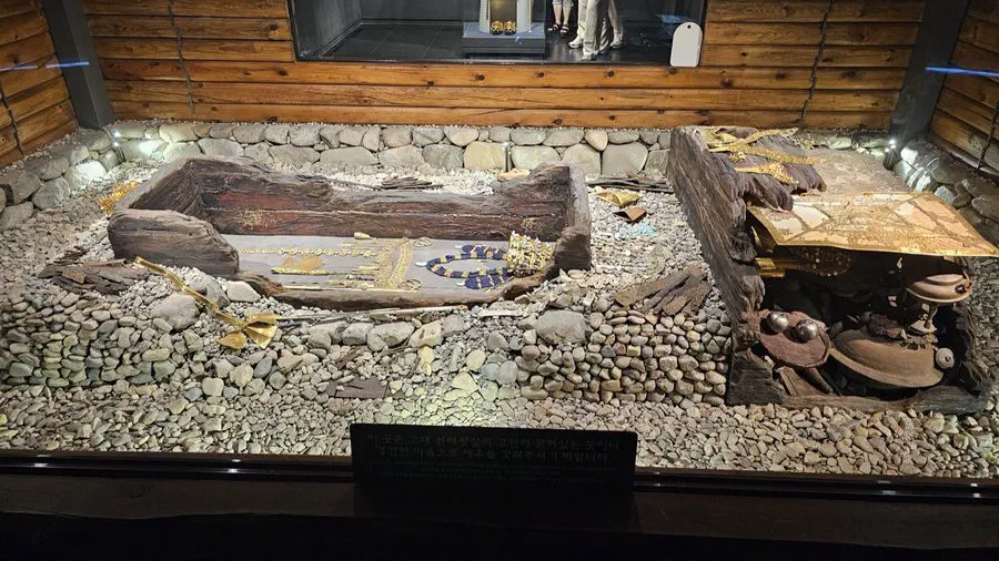 A museum-style exhibit of gold burial artifacts inside Cheonmachong