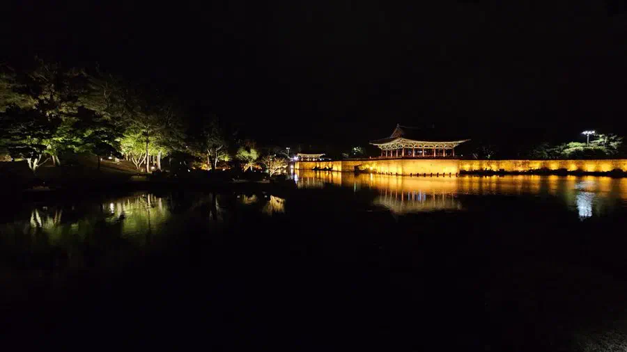 A lit pavilion at Donggung Palace reflected in Wolji pond at night