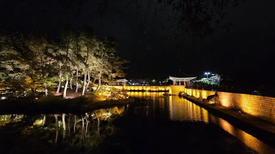 A bridge and lit pavilion at Donggung Palace and Wolji pond at night