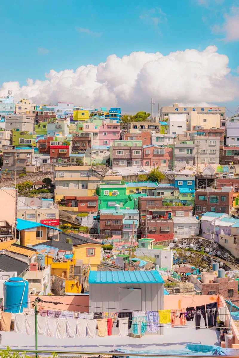 Colorful stepped houses climbing the hillside of Gamcheon Culture Village, Busan