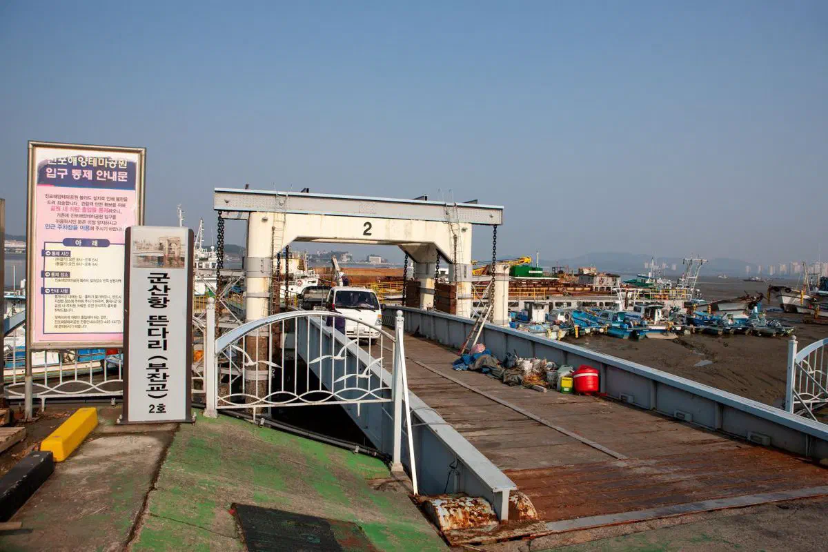 The floating pier docks at Gunsan's old inner harbor, a registered heritage structure from the port's 1930s working-harbor days