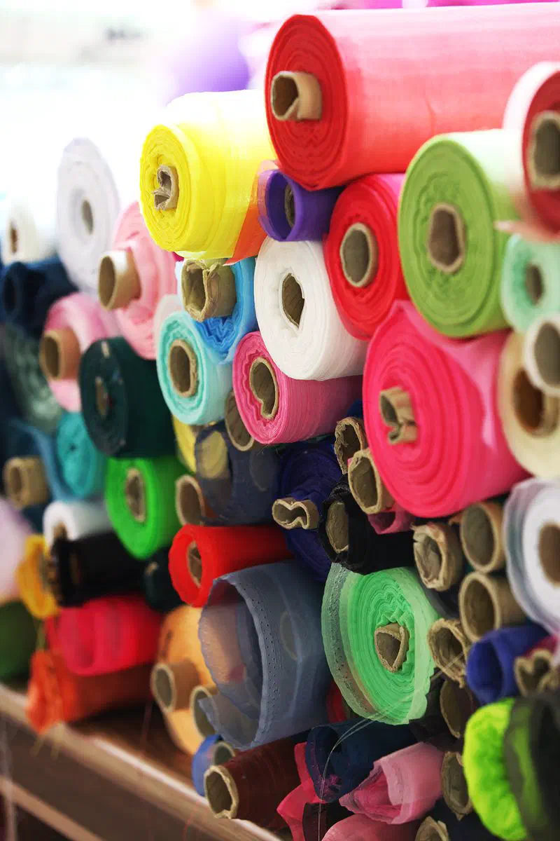 Rolls of fabric at a textile shop in Gwangjang Market — the market's original trade, and the reason its bedding stalls exist at all