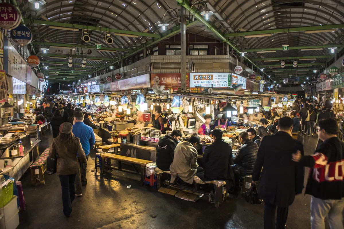 The covered food alley inside Gwangjang Market, Jongno-gu — the market's best-known section, a short walk from the bedding stalls