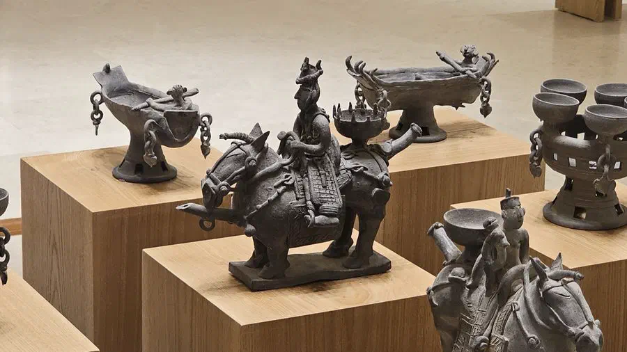 Silla-era earthenware vessels shaped like a mounted rider on horseback, displayed among other pottery vessels at the National Gyeongju Museum