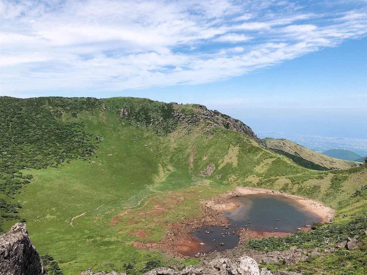 Baengnokdam, the crater lake at Hallasan's summit, seen from above with water visible after rain