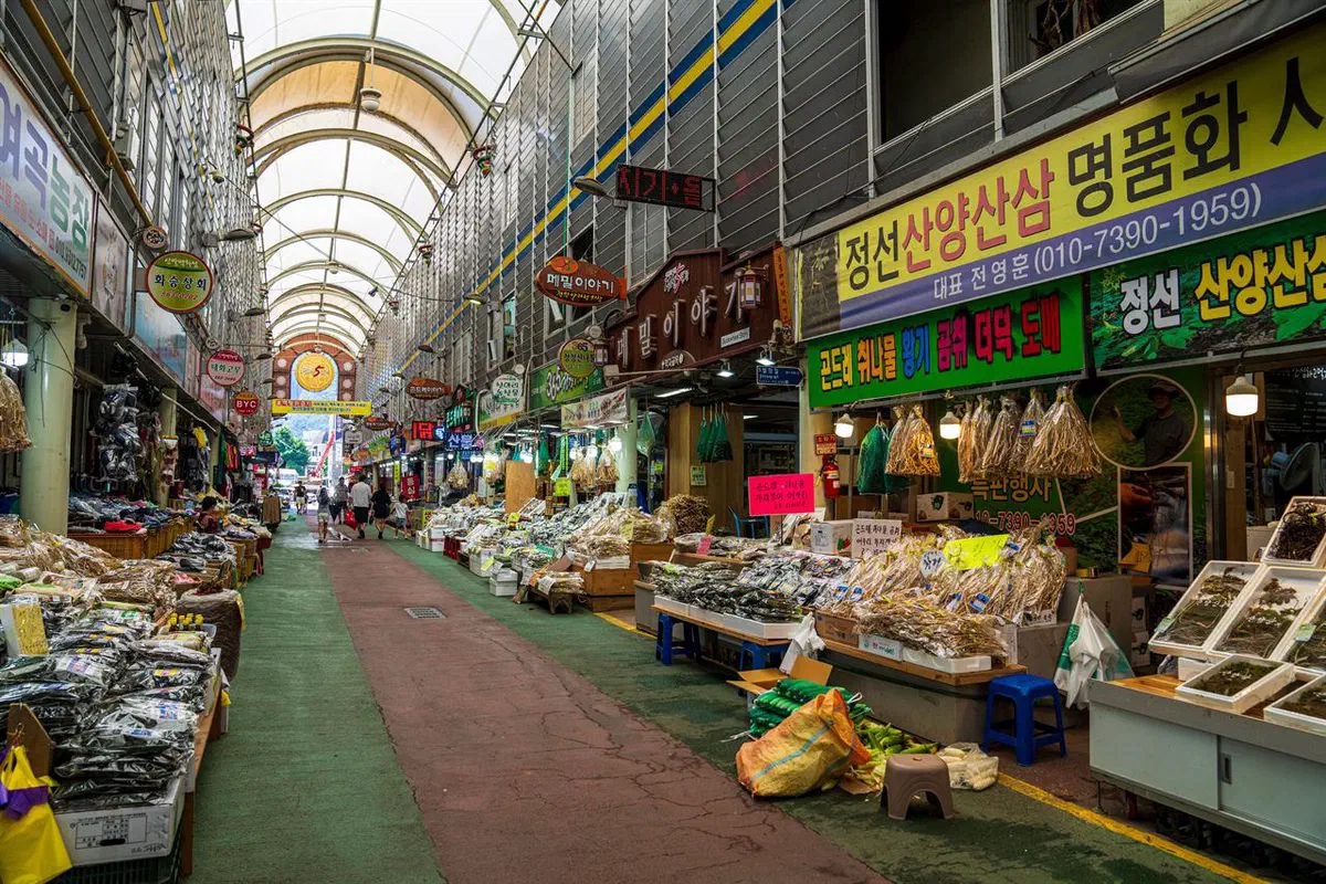 The covered arcade of Jeongseon's five-day market, stalls of dried mountain vegetables and herbs lining both sides of the walkway