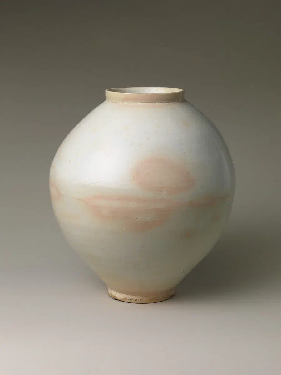 A Joseon-dynasty baekja moon jar, its faint horizontal seam visible at the widest point where two thrown halves were joined before firing