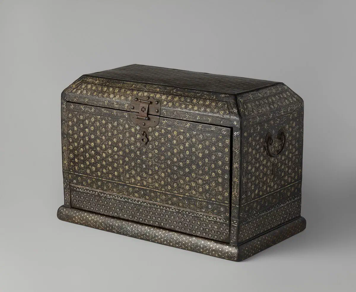 A Korean black-lacquer sutra box densely inlaid with mother-of-pearl in a chrysanthemum scroll pattern, with banded geometric borders, iron lock plate and side handles, on a moulded base