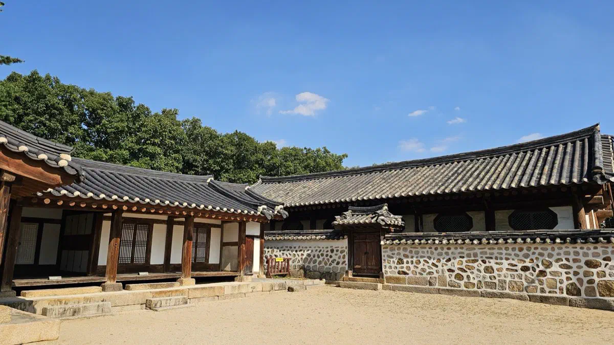 The courtyard of the tomb keeper's house at Seooreung, tiled roofs around bare earth