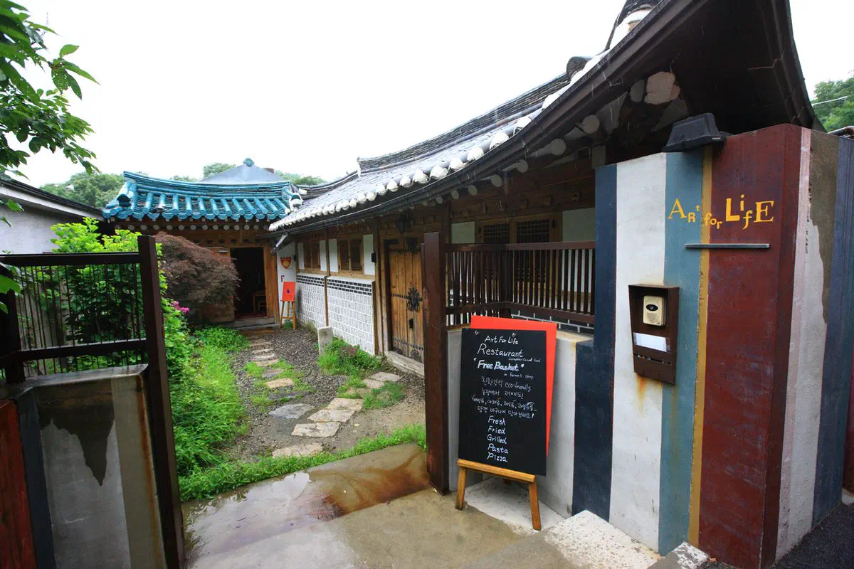 A hanok-style cafe on Buam-dong's café street, the Seoul neighborhood that stood in for a North Korean setting in Crash Landing on You and filmed Coffee Prince a decade earlier